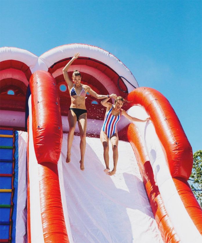 कब they took a joint leap of faith down a waterslide at Swift's Fourth of July bash. 