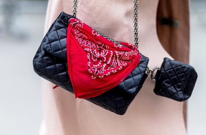 ए bandana looped around the hardware of a ladylike bag gives the look rock-n-roll edge. 