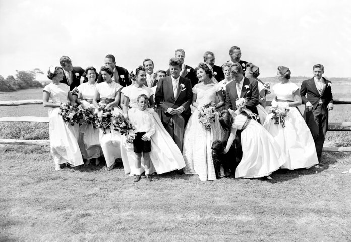  couple with their twenty attendants, page boy, and flower girl on their wedding day 
